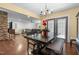 A dining room with an open doorway features a chandelier, dining table, and stone accent wall at 3216 Green Valley Dr, Sanford, NC 27330