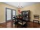 A dining room features a chandelier, dining table, and glass display cabinet with gray french doors at 3216 Green Valley Dr, Sanford, NC 27330