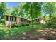 Exterior shot of home with mature trees on a well-maintained lawn at 3216 Green Valley Dr, Sanford, NC 27330