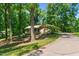 Beautiful single-story home nestled among mature trees, features a long driveway and lush landscaping at 3216 Green Valley Dr, Sanford, NC 27330