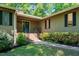 Inviting front entrance with a blue door, brick steps, decorative railing, and a well-manicured lawn at 3216 Green Valley Dr, Sanford, NC 27330