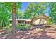 View of the home's exterior showcasing its charming curb appeal and mature landscaping at 3216 Green Valley Dr, Sanford, NC 27330