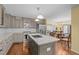 Stylish kitchen with a center island, stainless steel appliances, and an open layout connected to the dining area at 3216 Green Valley Dr, Sanford, NC 27330