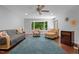 Spacious living room with a large bay window offering natural light and scenic views, hardwood floor and stylish furniture at 3216 Green Valley Dr, Sanford, NC 27330