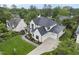 Aerial view of white, two-story house with a lush green lawn and a long driveway at 3407 Churchill Rd, Raleigh, NC 27607