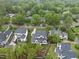 Aerial view of house with lawn, landscaping, neighborhood, and tree coverage at 3407 Churchill Rd, Raleigh, NC 27607