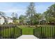 View of backyard from back porch and stairs with lawn and landscaping at 3407 Churchill Rd, Raleigh, NC 27607