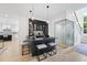Stylish wet bar with barstool seating, glass display cabinets, and adjacent glass-enclosed space at 3407 Churchill Rd, Raleigh, NC 27607