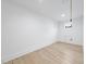 Unfinished basement area with light hardwood floors, white walls and a small window at 3407 Churchill Rd, Raleigh, NC 27607