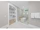 Elegant bathroom with a contemporary tub, glass shower enclosure, and walk-in closet at 3407 Churchill Rd, Raleigh, NC 27607