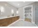 Luxurious bathroom with double vanity, walk-in closet, and contemporary lighting fixtures at 3407 Churchill Rd, Raleigh, NC 27607