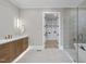 Modern bathroom featuring wood cabinetry, a glass-enclosed shower, and walk-in closet access at 3407 Churchill Rd, Raleigh, NC 27607