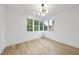 Bright bedroom with natural light streaming through multiple windows, highlighting the hardwood floors at 3407 Churchill Rd, Raleigh, NC 27607