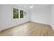 Light-filled bedroom featuring hardwood floors and a wall of windows providing natural light at 3407 Churchill Rd, Raleigh, NC 27607