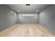 Large bonus room with contemporary lighting fixture and hardwood flooring at 3407 Churchill Rd, Raleigh, NC 27607