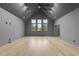Large bonus room with vaulted ceiling, fan, and ample natural light at 3407 Churchill Rd, Raleigh, NC 27607