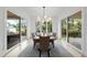 Bright dining room with wood table and chairs, elegant chandelier, and glass doors to outside at 3407 Churchill Rd, Raleigh, NC 27607