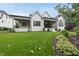 Two-story home with white siding, a well-manicured lawn, and covered patios at 3407 Churchill Rd, Raleigh, NC 27607