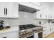 Close up of kitchen details featuring stainless steel oven and range with white stone backsplash at 3407 Churchill Rd, Raleigh, NC 27607