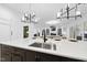 Gourmet kitchen with an island featuring a sink, white stone countertops, and views to the living room at 3407 Churchill Rd, Raleigh, NC 27607