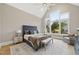 Spacious main bedroom with high ceilings, a large window, and a cozy seating area at 3407 Churchill Rd, Raleigh, NC 27607