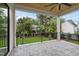 Open-air patio with ceiling fan, stone flooring, and backyard view at 3407 Churchill Rd, Raleigh, NC 27607