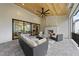 Covered outdoor patio featuring a stone fireplace, comfortable seating, and backyard views at 3407 Churchill Rd, Raleigh, NC 27607