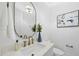 Modern powder room with marble countertop, gold fixtures, oval mirror, and decorative accents at 3407 Churchill Rd, Raleigh, NC 27607