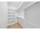 Bright, white walk-in closet with custom shelving and wood floors, maximizing storage at 3407 Churchill Rd, Raleigh, NC 27607