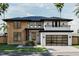Stunning two-story home with modern design, wood accents, and a black-trimmed garage door at 3801 Peaceful Creek Trl, Zebulon, NC 27597