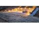 Outdoor lounge area with a fire pit, built-in seating, and ambient lighting for evening relaxation and enjoyment at 400 Access Dr, Youngsville, NC 27596