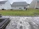 View of the backyard and patio with a built in fire pit and privacy fence at 400 Access Dr, Youngsville, NC 27596