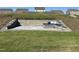 Landscaped backyard with a stone patio, a cozy fire pit, and comfortable built-in seating at 400 Access Dr, Youngsville, NC 27596