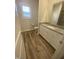 Bathroom featuring modern vanity with stone countertop and wood look floors at 400 Access Dr, Youngsville, NC 27596