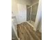 Bathroom with stylish floors, granite vanity, and a shower with glass doors at 400 Access Dr, Youngsville, NC 27596