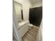 Bathroom featuring a granite vanity top, mirror, and a shower with a black curtain at 400 Access Dr, Youngsville, NC 27596