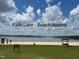 Falls Lake offers beach access with a sandy shore and views of the water under a partly cloudy sky at 400 Access Dr, Youngsville, NC 27596
