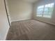 Bedroom featuring plush carpeting, a closet, and natural lighting from a window overlooking the neighborhood at 400 Access Dr, Youngsville, NC 27596