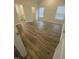 Bedroom featuring hardwood floors, a closet, and an attached bathroom with updated finishes at 400 Access Dr, Youngsville, NC 27596
