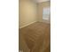 A cozy bedroom features neutral-colored walls, carpet, and a window at 400 Access Dr, Youngsville, NC 27596