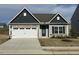 Charming single-story home with stone accents, attached garage, and well-maintained lawn at 400 Access Dr, Youngsville, NC 27596