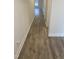 Hallway view showcasing the flooring and natural light with a neutral paint palette to complement any design at 400 Access Dr, Youngsville, NC 27596