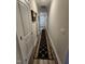 Hallway with dark runner, white doors, and neutral walls at 400 Access Dr, Youngsville, NC 27596