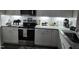 Kitchen features stainless appliances, granite counters, white cabinets, and subway tile backsplash at 400 Access Dr, Youngsville, NC 27596