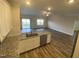 Modern kitchen features stainless appliances, granite counters, white cabinets and flows into a large living space at 400 Access Dr, Youngsville, NC 27596