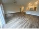 Spacious open-concept living room featuring hardwood floors and natural light, with a view of the kitchen area at 400 Access Dr, Youngsville, NC 27596