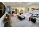 Bright and airy living room featuring hardwood floors, open to a modern kitchen and dining area at 400 Access Dr, Youngsville, NC 27596