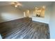 Open-concept living room with hardwood floors flowing into the bright kitchen area at 400 Access Dr, Youngsville, NC 27596