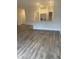 Open-concept living room with hardwood floors and views of the kitchen area at 400 Access Dr, Youngsville, NC 27596