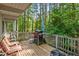 Cozy wooden deck with outdoor seating and a grill, perfect for enjoying the surrounding lush greenery at 4501 Zebulon Rd, Zebulon, NC 27597